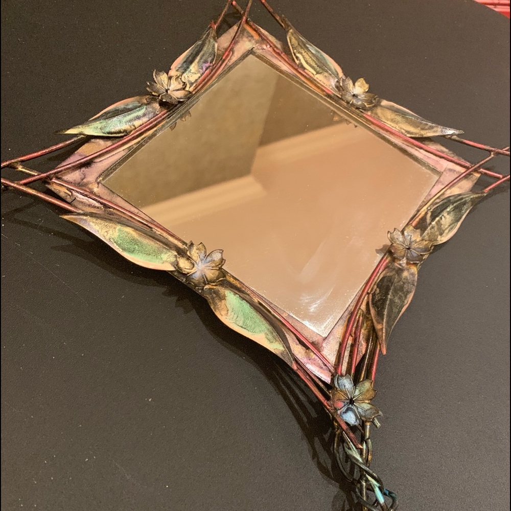 Whimsical metal artisan mirror.